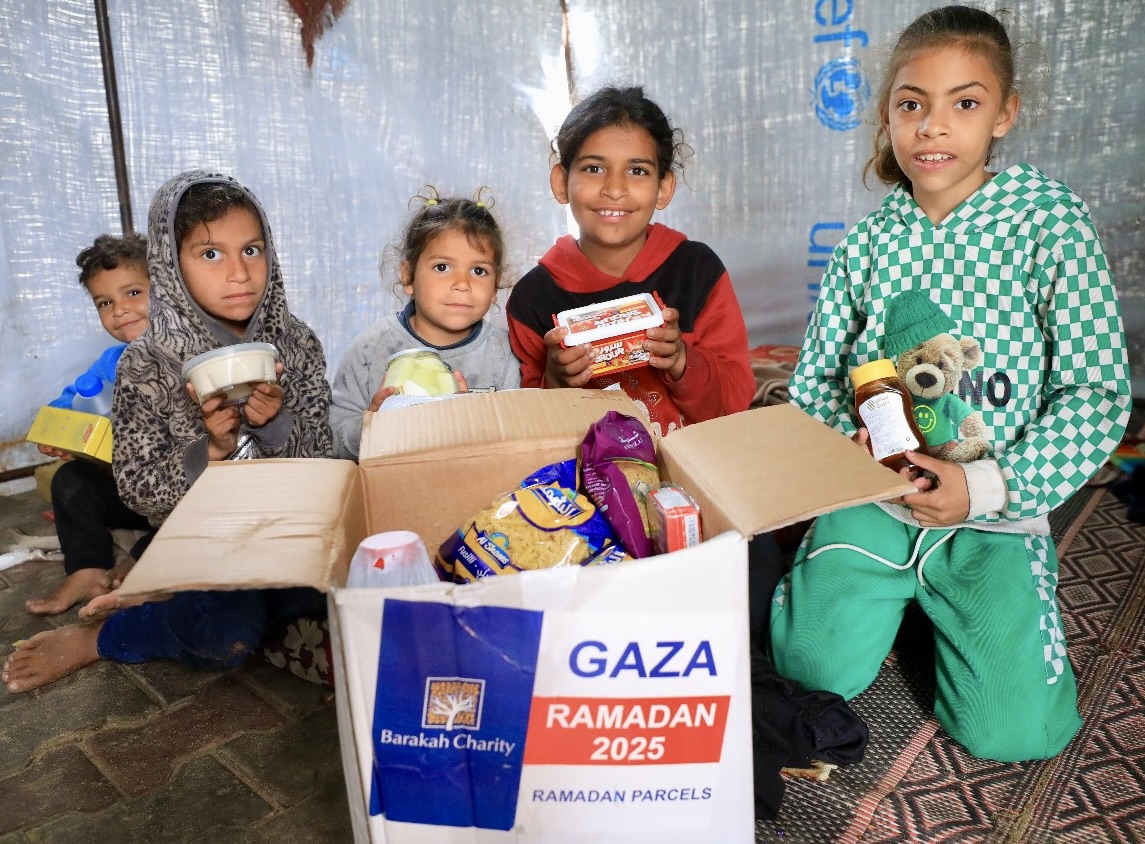 "Happy children opening a Ramadan parcel filled with food"