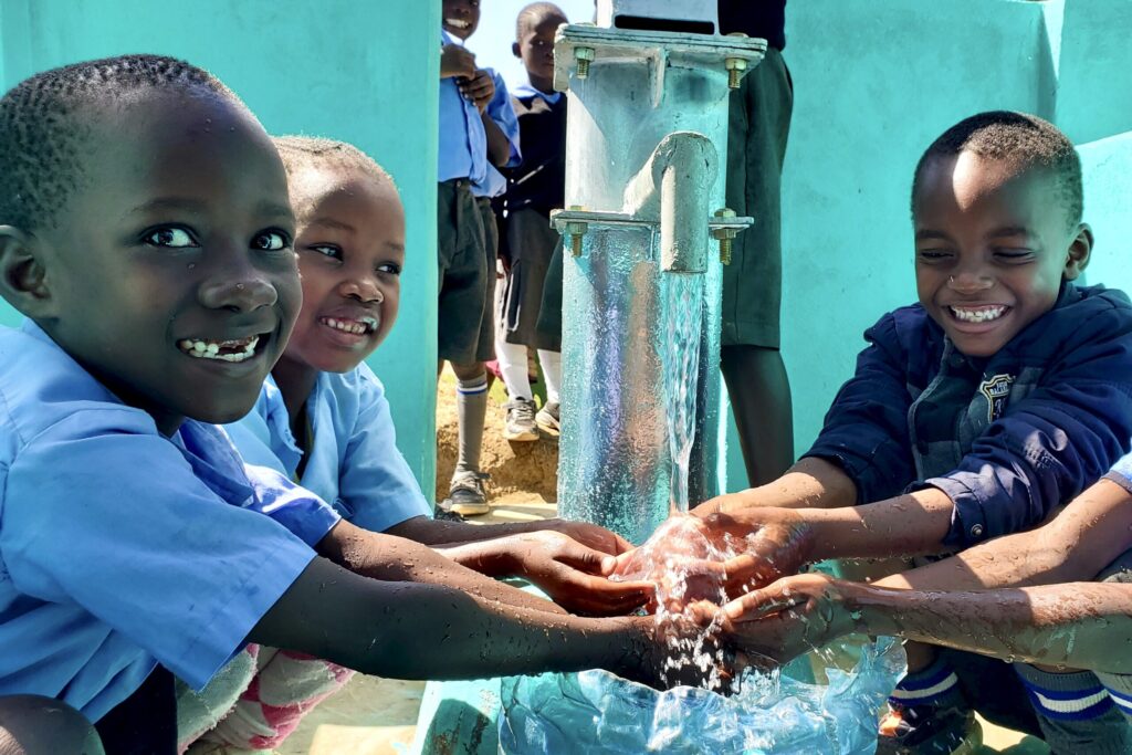 Children in African villages at well inauguration ceremonies